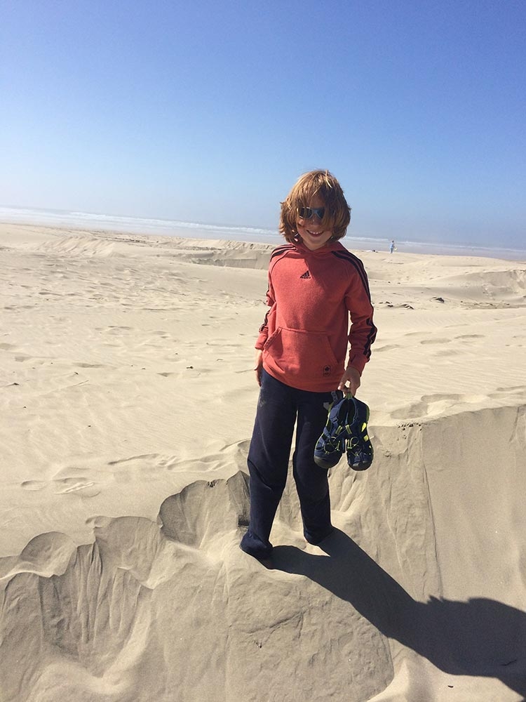 Woo hoo! Carson in the sand dunes on the beach