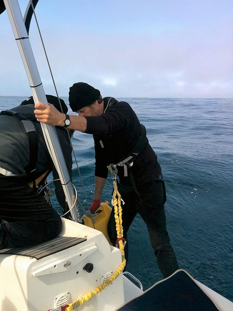 Refueling at sea from our jerry cans. Tricky to do, even in glassy seas!